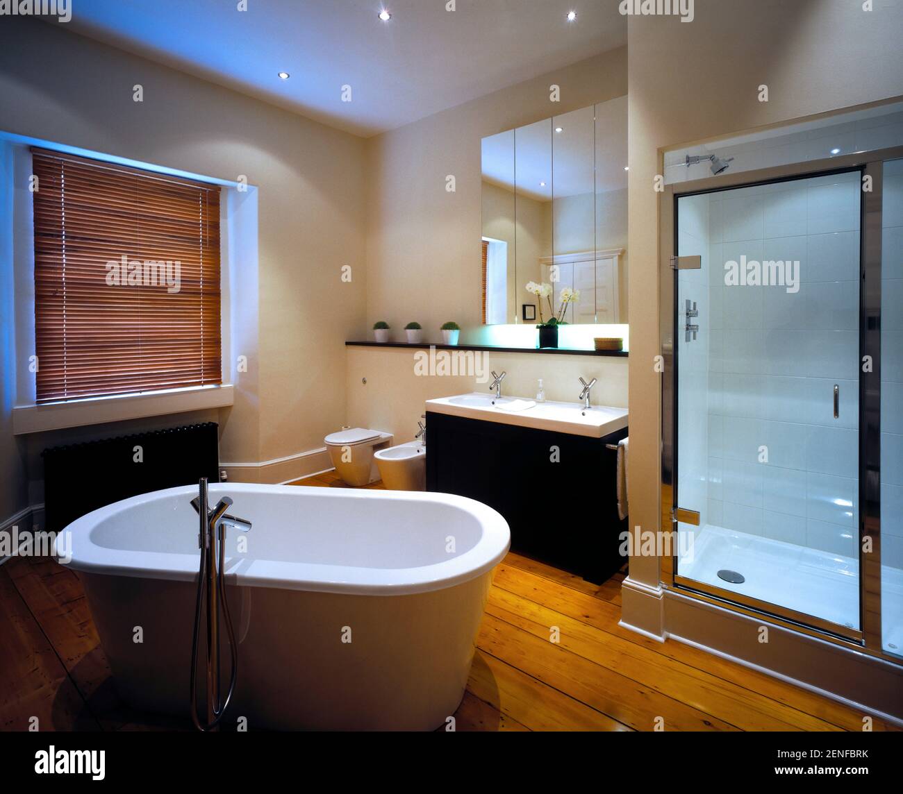 Contemporary bathroom with wooden window blinds and wooden floor Stock