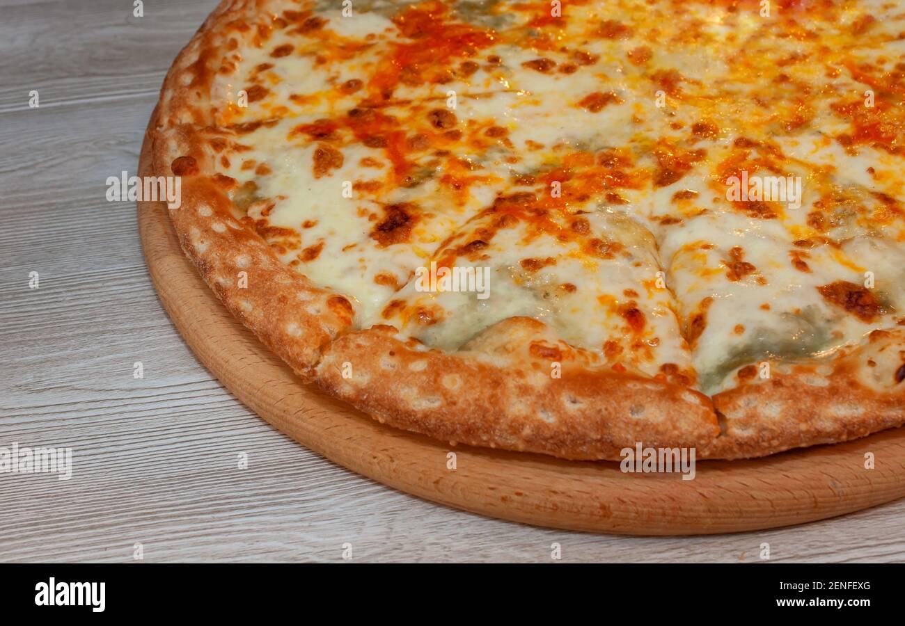 Four cheese pizza on a board Stock Photo