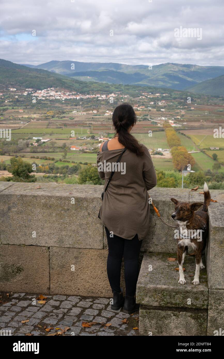 Caucasian woman and a dog in Belmonte landscape view of Serra da Estrela mountain natural park, in Portugal Stock Photo