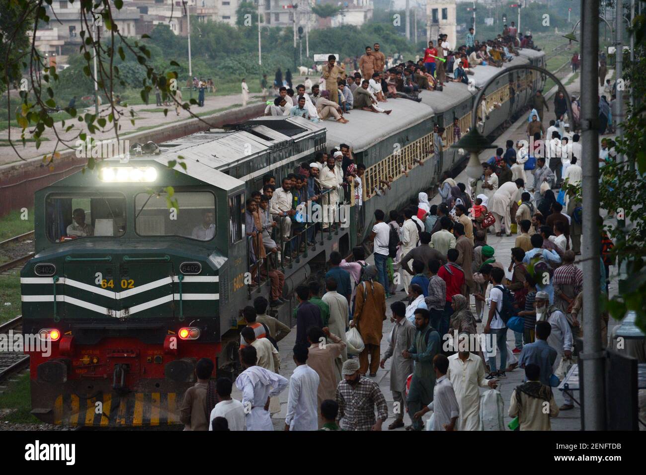 Pakistani passengers climb on the train roof top just to catch a ride ...
