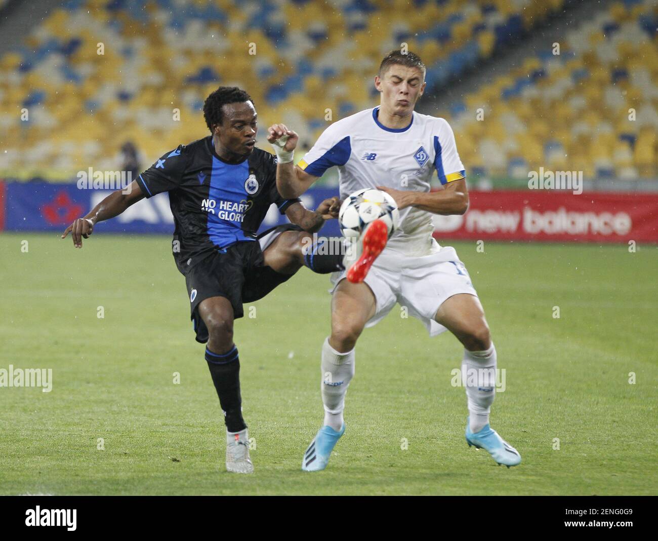 Percy Muzi Tau Of Brugge L And Vitaliy Mykolenko Of Dynamo Kyiv R Are Seen In Action During The Uefa Champions League Third Qualifying Round Second Leg Football Match Between Fc Dynamo