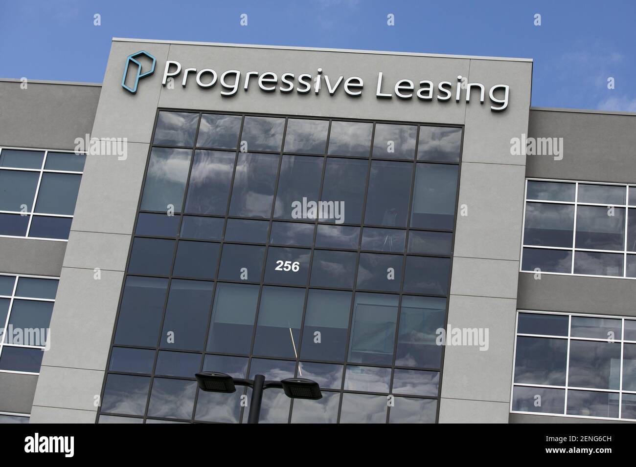 A logo sign outside of the headquarters of Progressive Leasing in