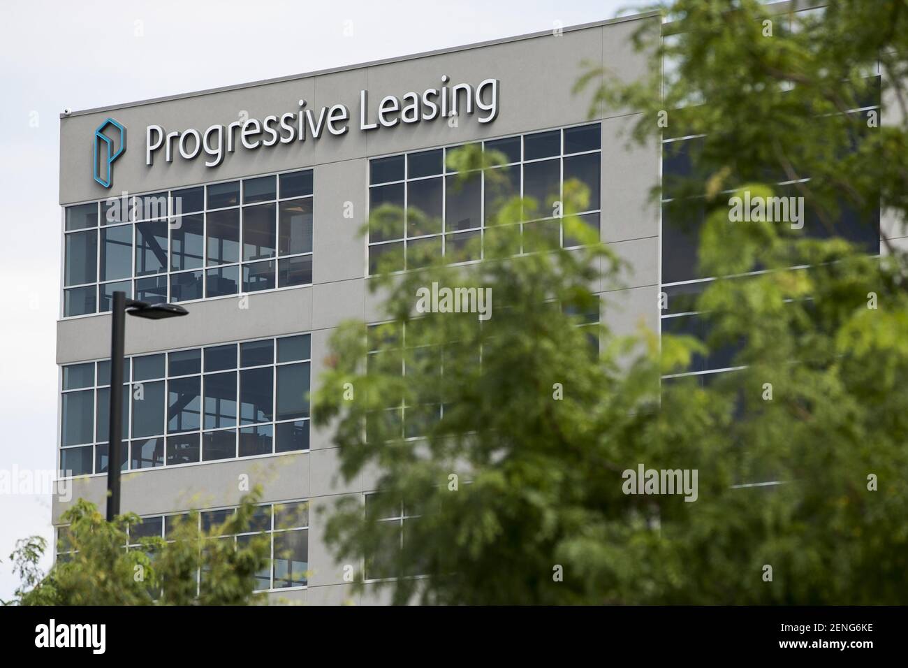 A logo sign outside of the headquarters of Progressive Leasing in