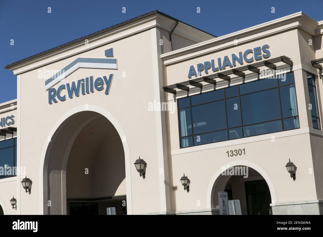 A logo sign outside of a RC Willey Home Furnishings retail store