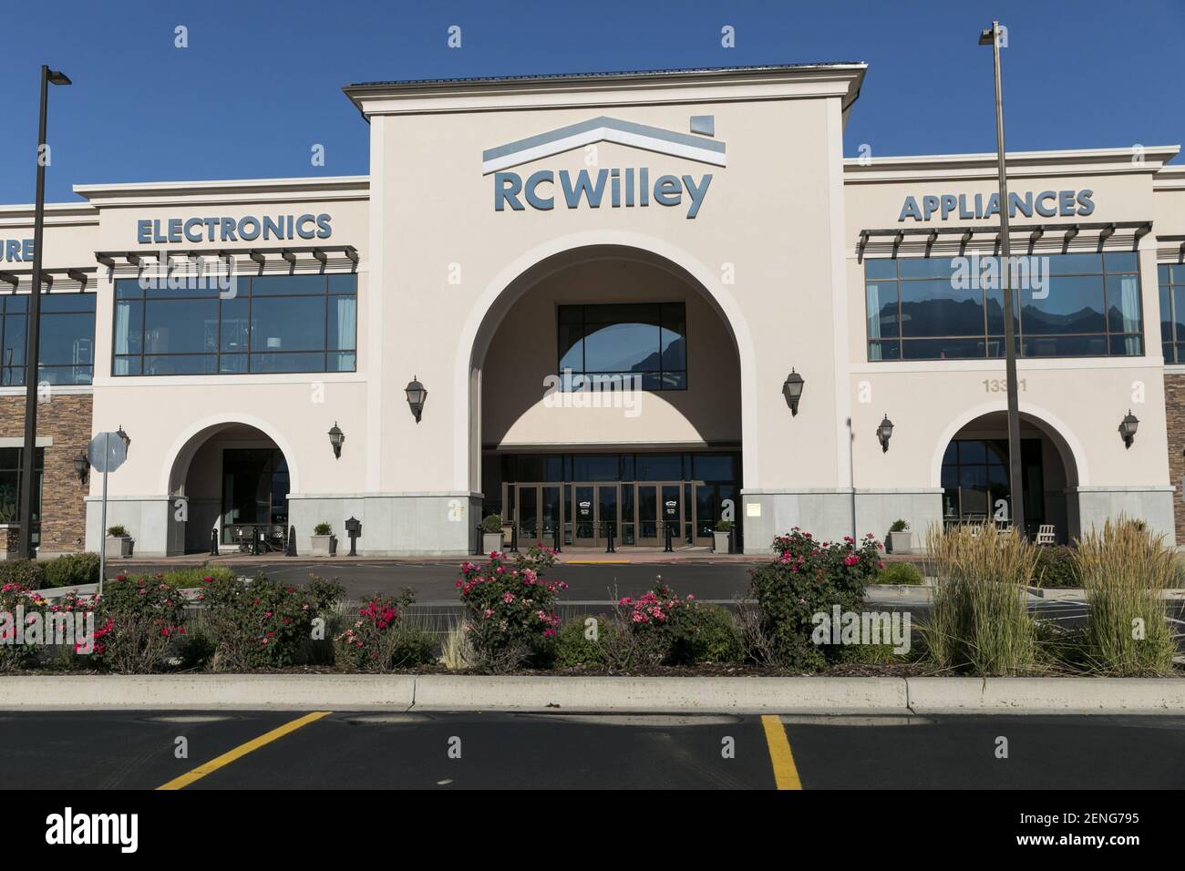 A logo sign outside of a RC Willey Home Furnishings retail store