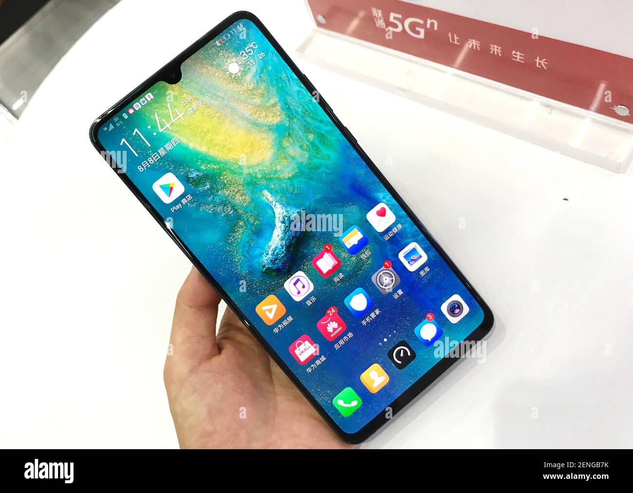 A customer tries out a Huawei Mate 20 X 5G smartphone at a branch of China  Unicom in Nanjing city, east China's Jiangsu province, 16 August 2019. EE  and Vodafone put a