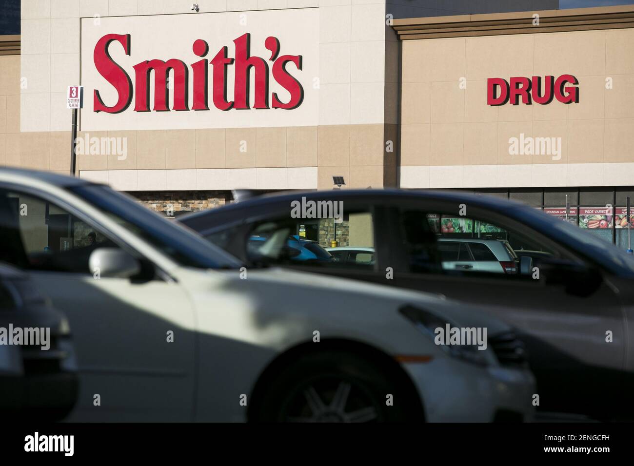 A logo sign outside of a Smith's Food and Drug retail grocery store location in Orem, Utah on
