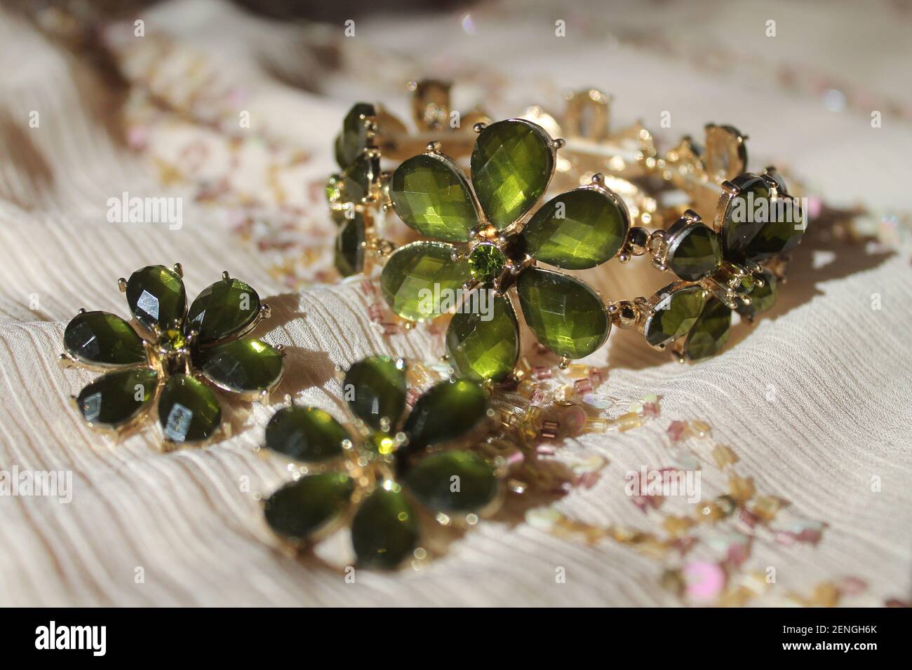 beautiful shine jewelry set bracelet with earrings in shape of the green flowers Stock Photo