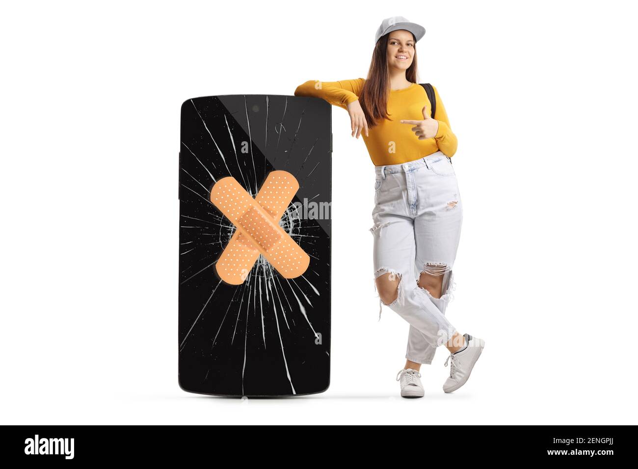 Full length portrait of a female student leaning on a phone with cracked screen and bandage and pointing isolated on white background Stock Photo
