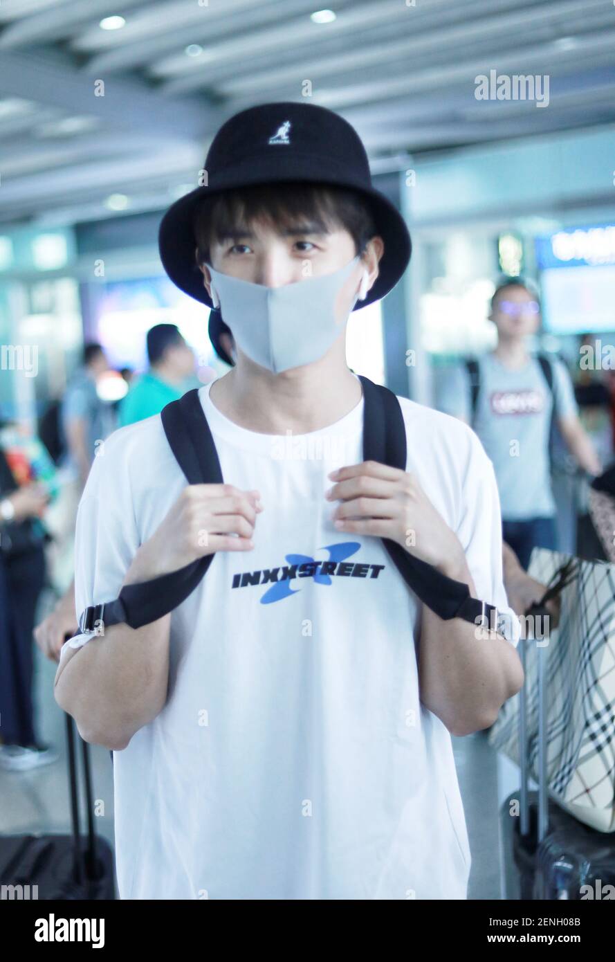 Chinese actor and singer Zhang Yuan arrives at the Beijing Capital International Airport before departure in Beijing China 18 August 2019. T shirt INXX Trousers INXX Bucket hat Kangol Photo by Stringe...
