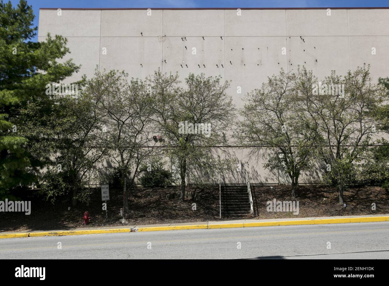 The faded outline of a Dillard's logo sign outside of a closed and