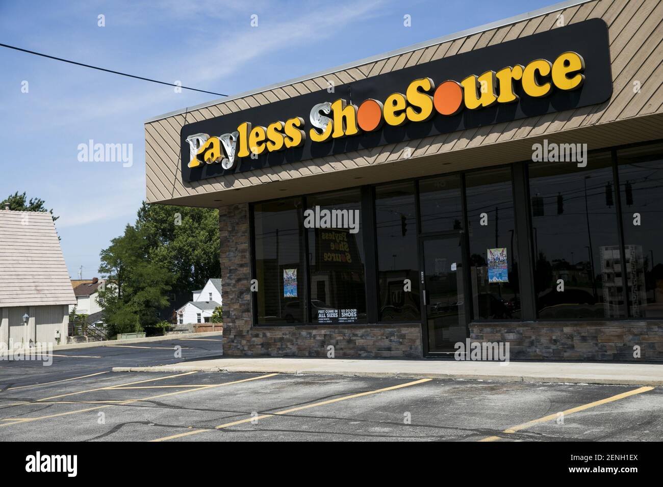 A logo sign outside of a closed Payless ShoeSource retail store ...