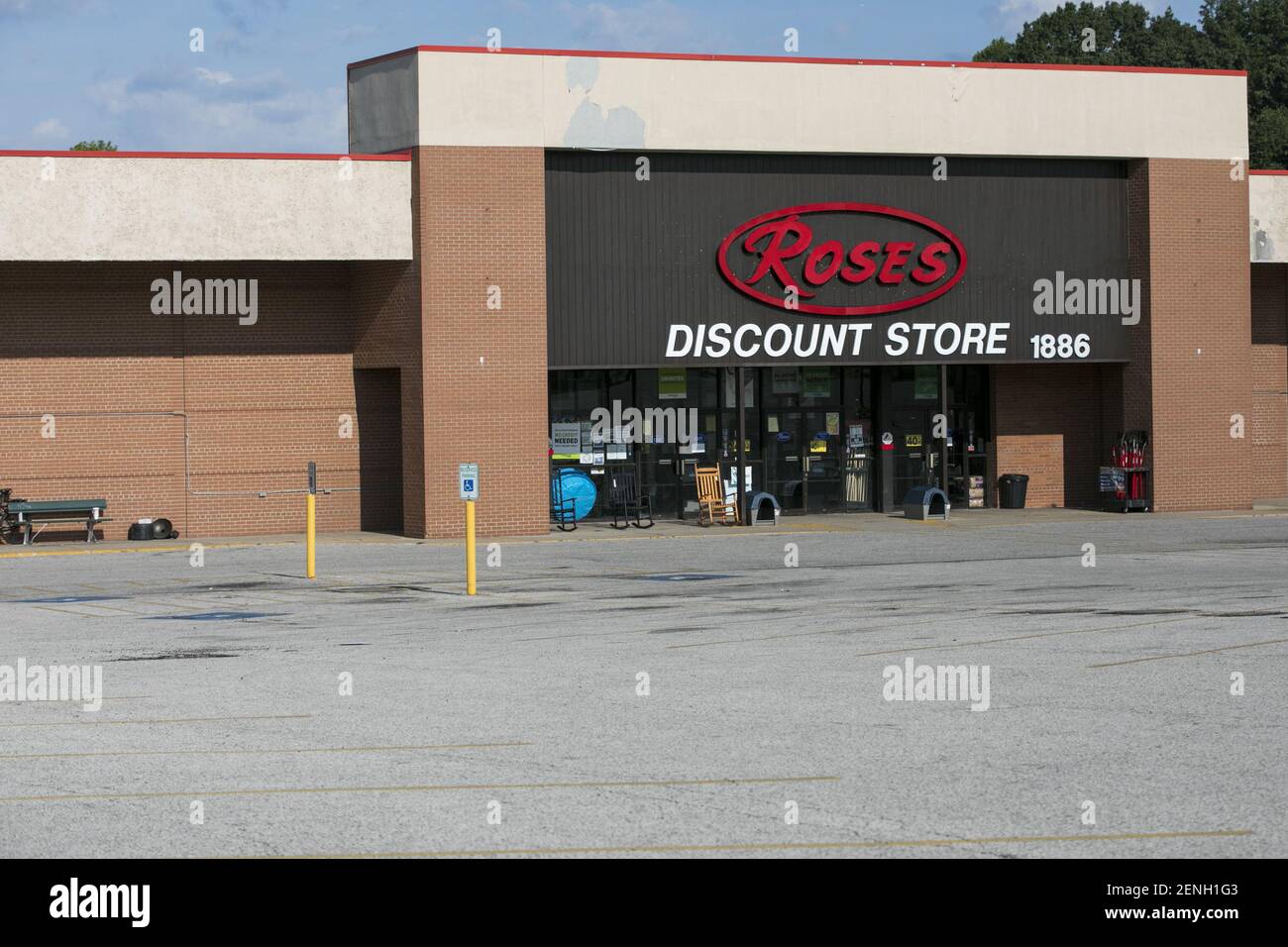 A logo sign outside of a Roses Discount retail store location in Akron
