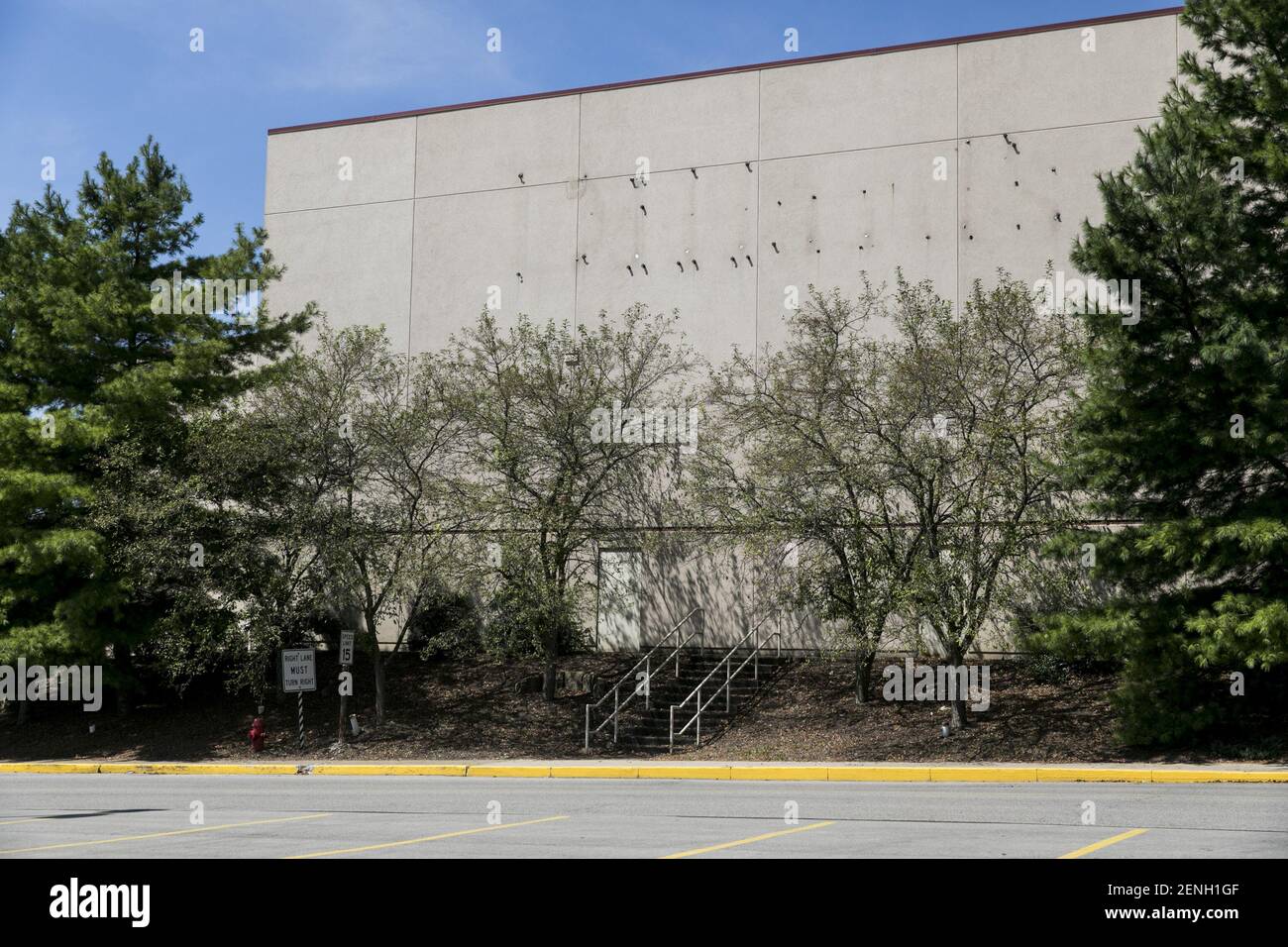 The faded outline of a Dillard's logo sign outside of a closed and