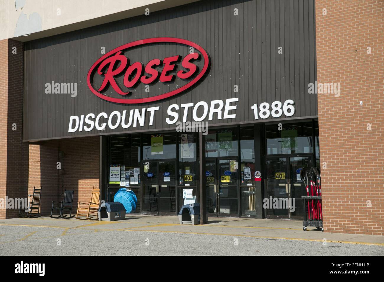 A logo sign outside of a Roses Discount retail store location in Akron