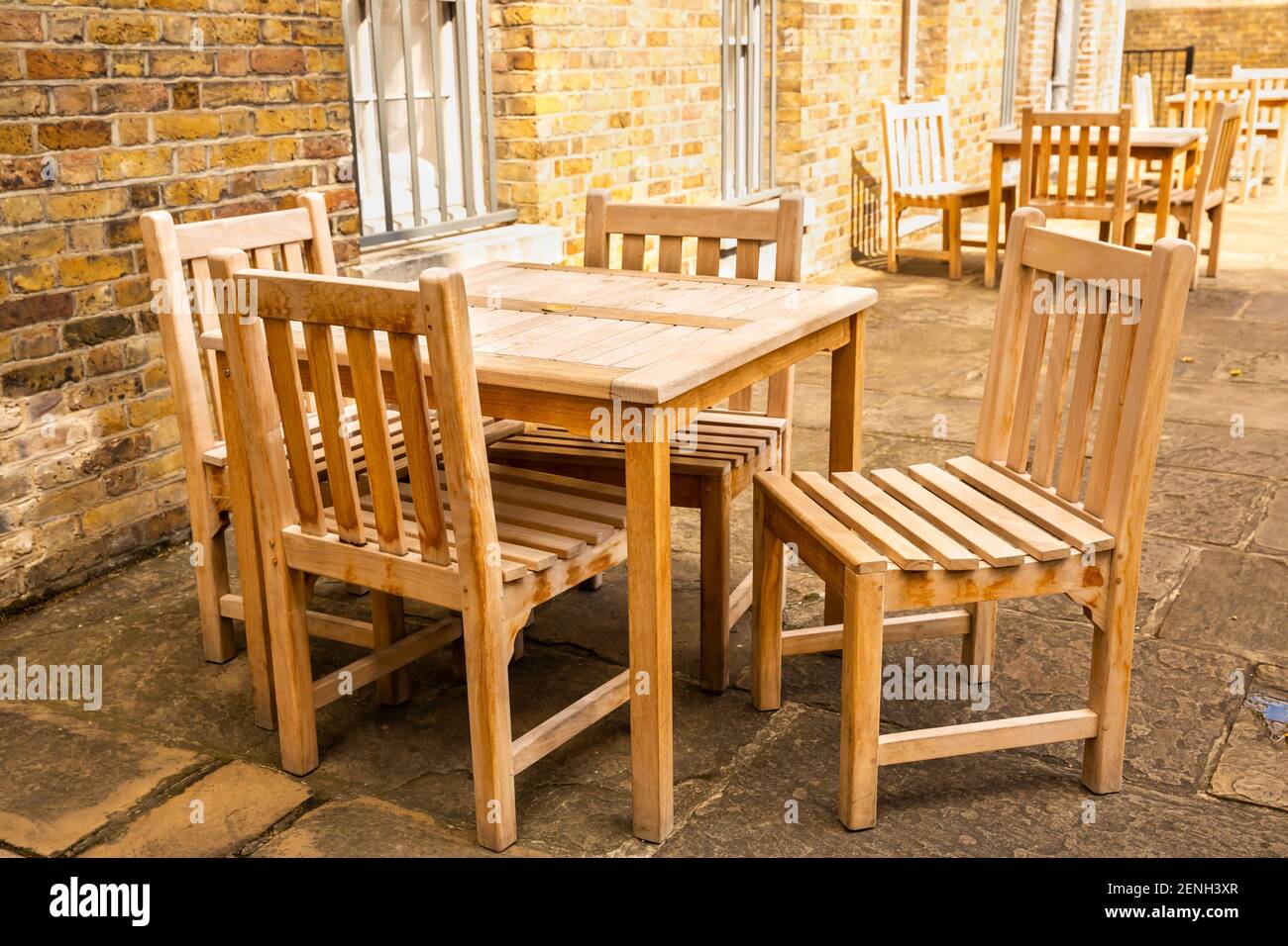Wooden tables and chairs of outdoors cafe in London. Stock Photo