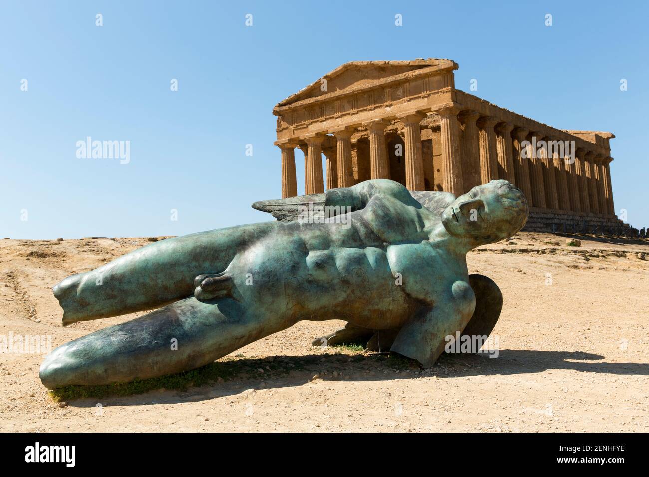 Italy, Sicily, Agrigento, Valley of the Temples, Temple of Concord (5th century BC) with a bronze statue of Fallen Icarus Stock Photo