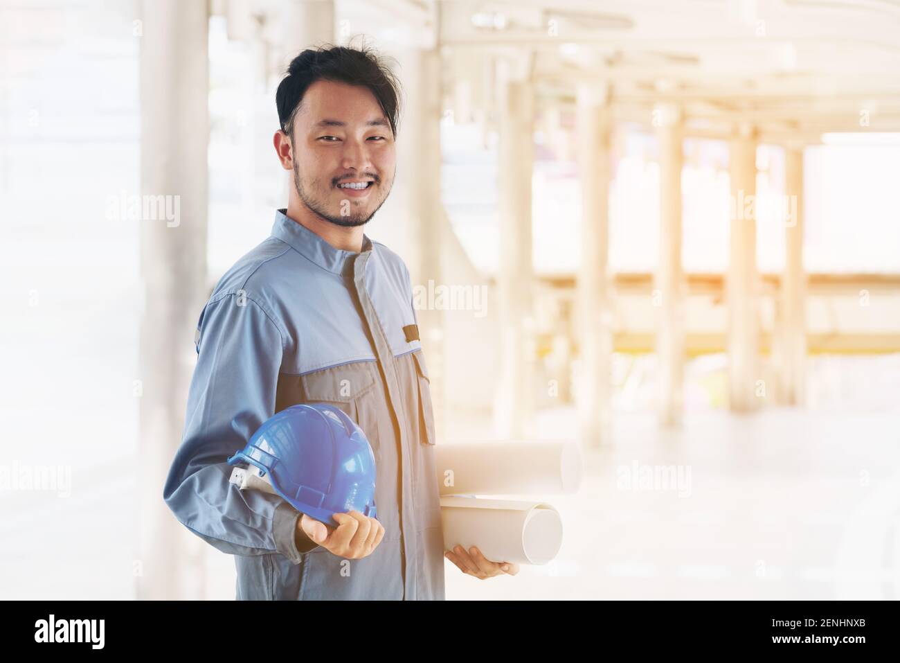 Portrait of happy engineer. East Asian ; Japanese, Chinese, Korean engineer looking at camera, smile. Engineering people concept. Stock Photo