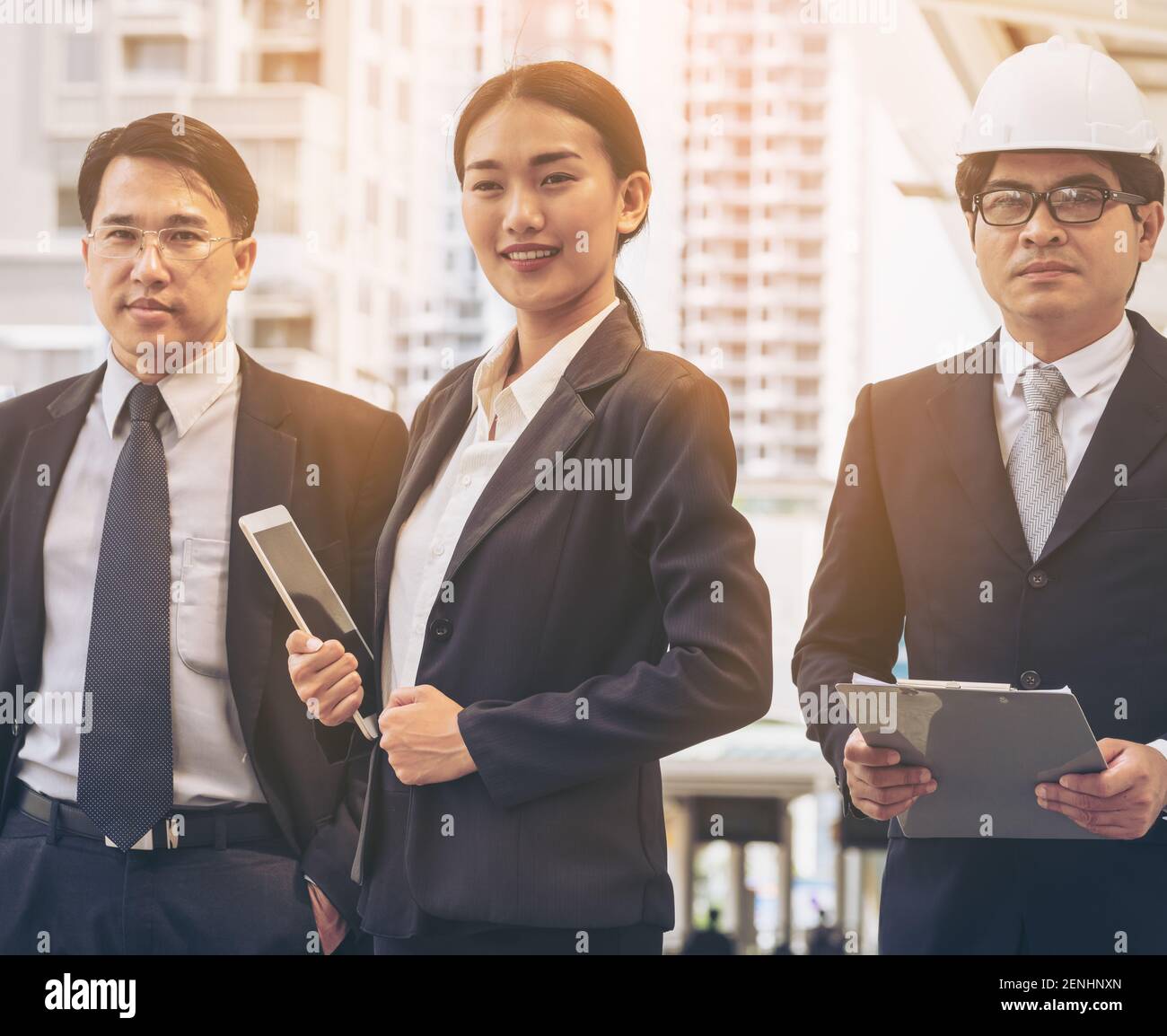 Woman leadership - Smart business woman standing with confidence in front of business men. Leadership of woman concept. Stock Photo