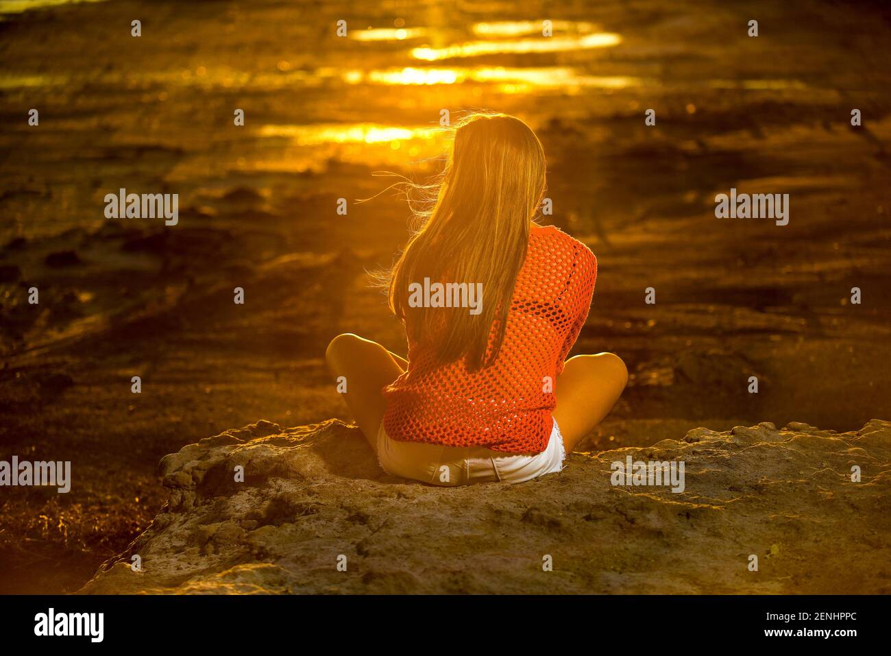 Woman looking the sunset Stock Photo