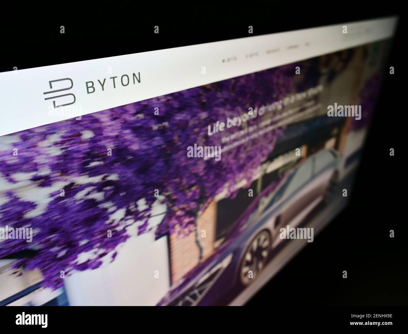 High angle view of website of Chinese automotive brand Byton (electric vehicle) on monitor with business logo. Focus on top-left of screen display. Stock Photo