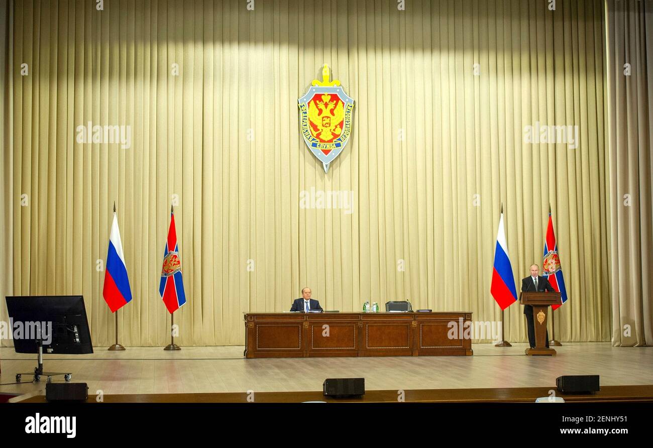 Russian President Vladimir Putin addresses a meeting of the Federal Security Service Board at the Kremlin February 24, 2021 in Moscow, Russia. Director of the FSB Alexander Bortnikov looks on. Stock Photo