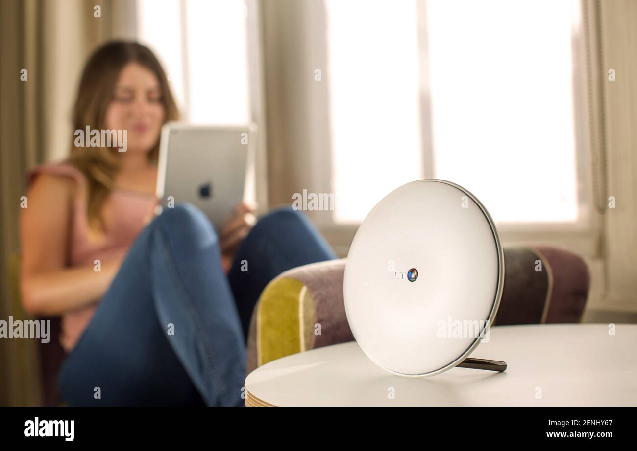 Home wifi router with women looking at web on iPad Stock Photo