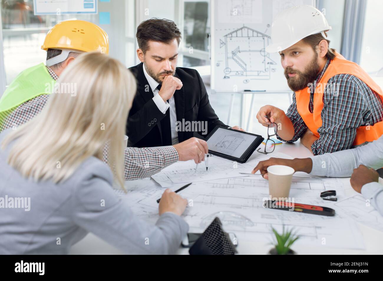 Multiracial office workers having meeting about construction Stock Photo
