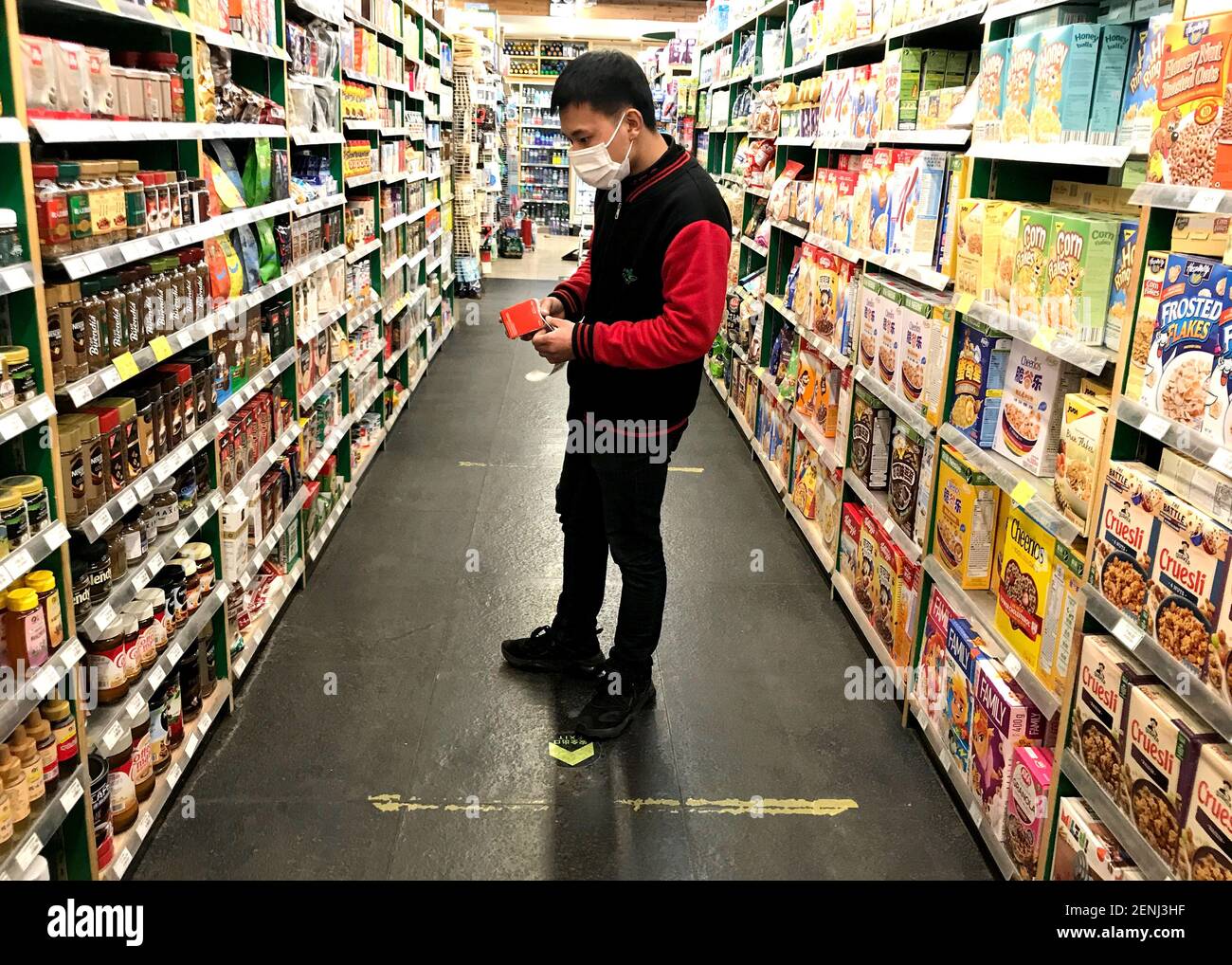 Beijing, China. 26th Feb, 2021. Chinese store clerks stock shelves with imported food items at an upscale 'Western' supermarket in downtown Beijing on Friday, February 26, 2021. China is placing greater emphasis on food security and self-reliance to feed its 1.4 billion people, according to its annual blueprint for rural policies amid the pandemic. Photo by Stephen Shaver/UPI Credit: UPI/Alamy Live News Stock Photo