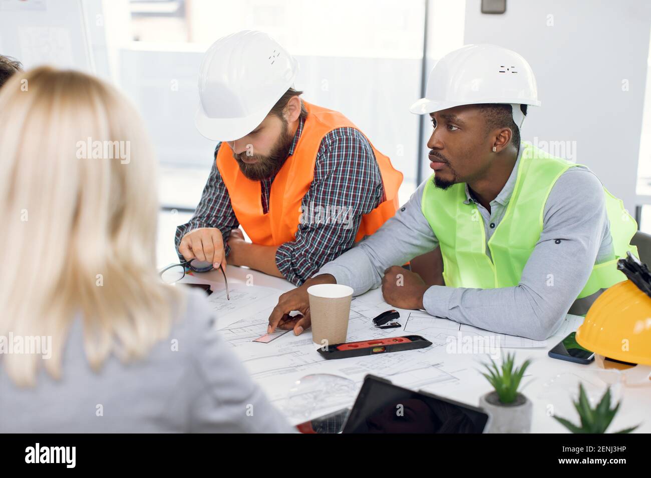 Multiracial office workers having meeting about construction Stock Photo