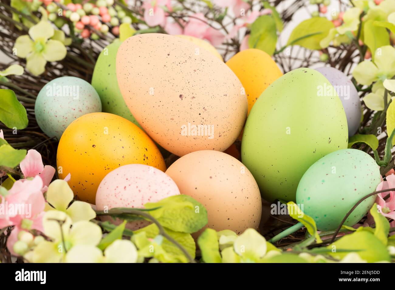 Easter colorful eggs in nest and flowers Stock Photo - Alamy