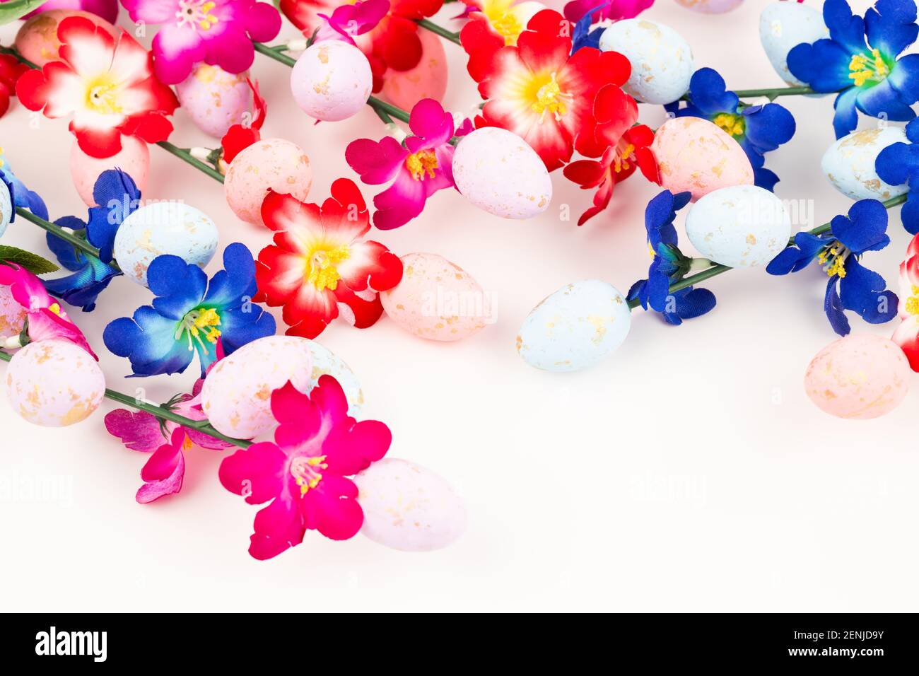 Easter colorful eggs and flowers on white background Stock Photo - Alamy