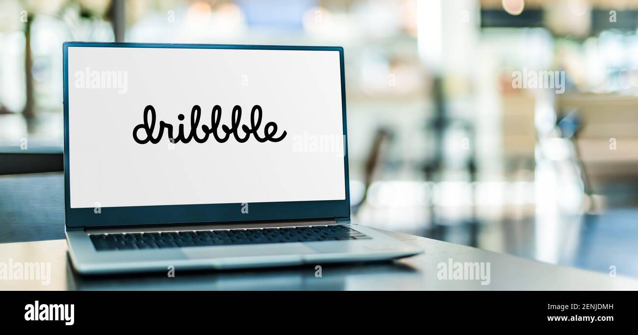 POZNAN, POL - JAN 6, 2021: Laptop computer displaying logo of Dribbble, a self-promotion and social networking platform for digital designers and crea Stock Photo