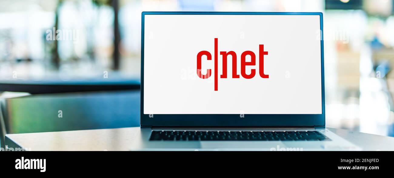 POZNAN, POL - JAN 6, 2021: Laptop computer displaying logo of CNET, an American media website that publishes reviews, news, articles, blogs, podcasts, Stock Photo