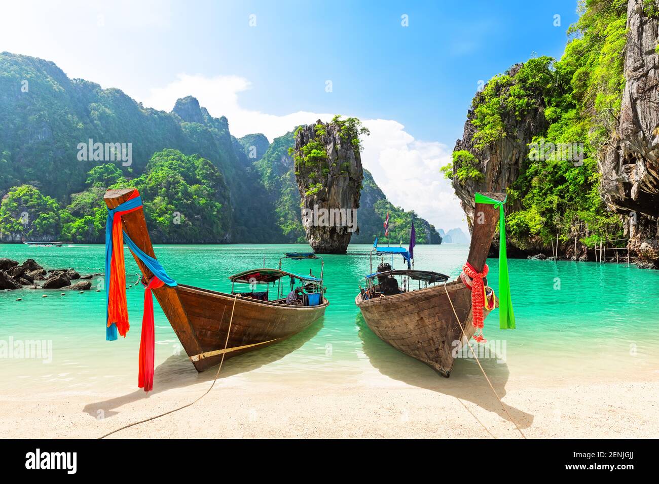Famous James Bond island near Phuket in Thailand. Travel photo of James Bond island with thai traditional wooden longtail boat and beautiful sand beac Stock Photo