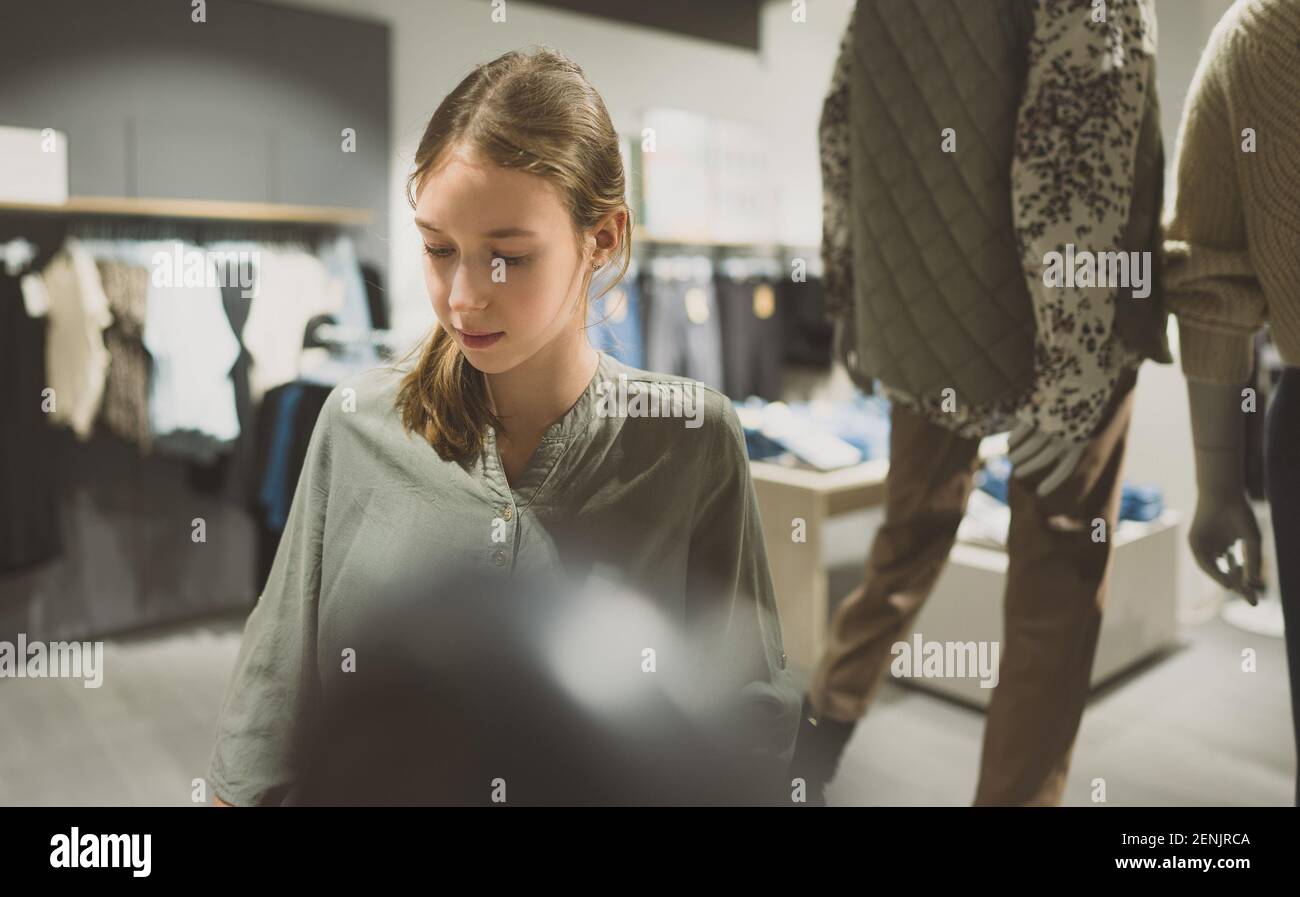 Attractive tween girl in a clothing store. Stock Photo