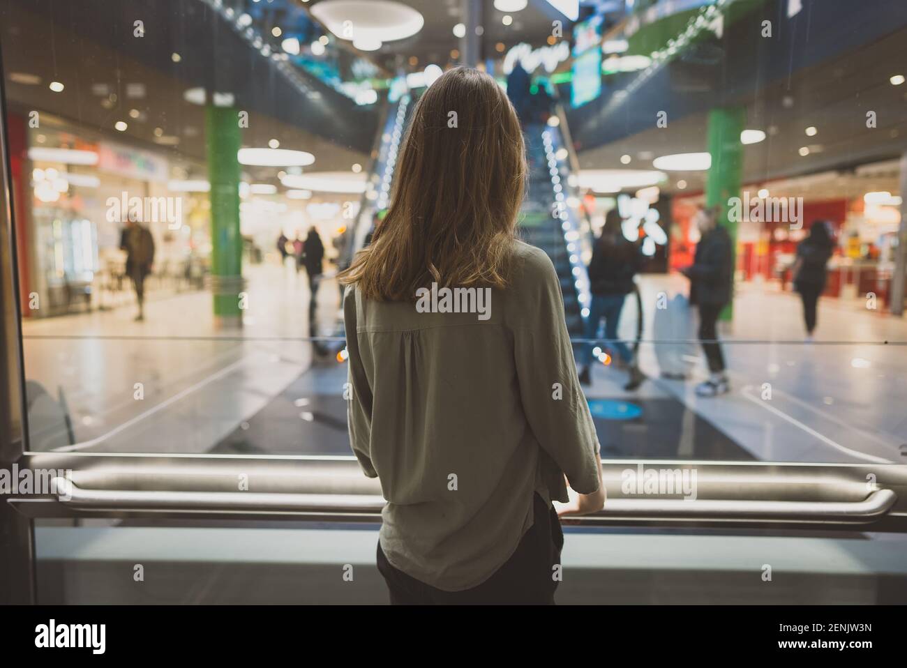 Girl in lift in a large shopping center. Stock Photo