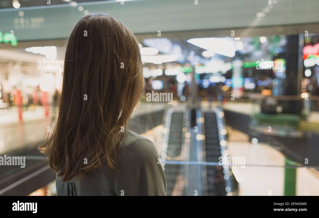 Girl in lift in a large shopping center. Stock Photo