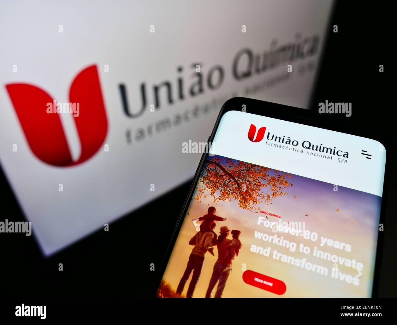 Cellphone with business website of Brazilian company União Química Farmacêutica Nacional SA on screen with logo. Focus on top-left of phone display. Stock Photo