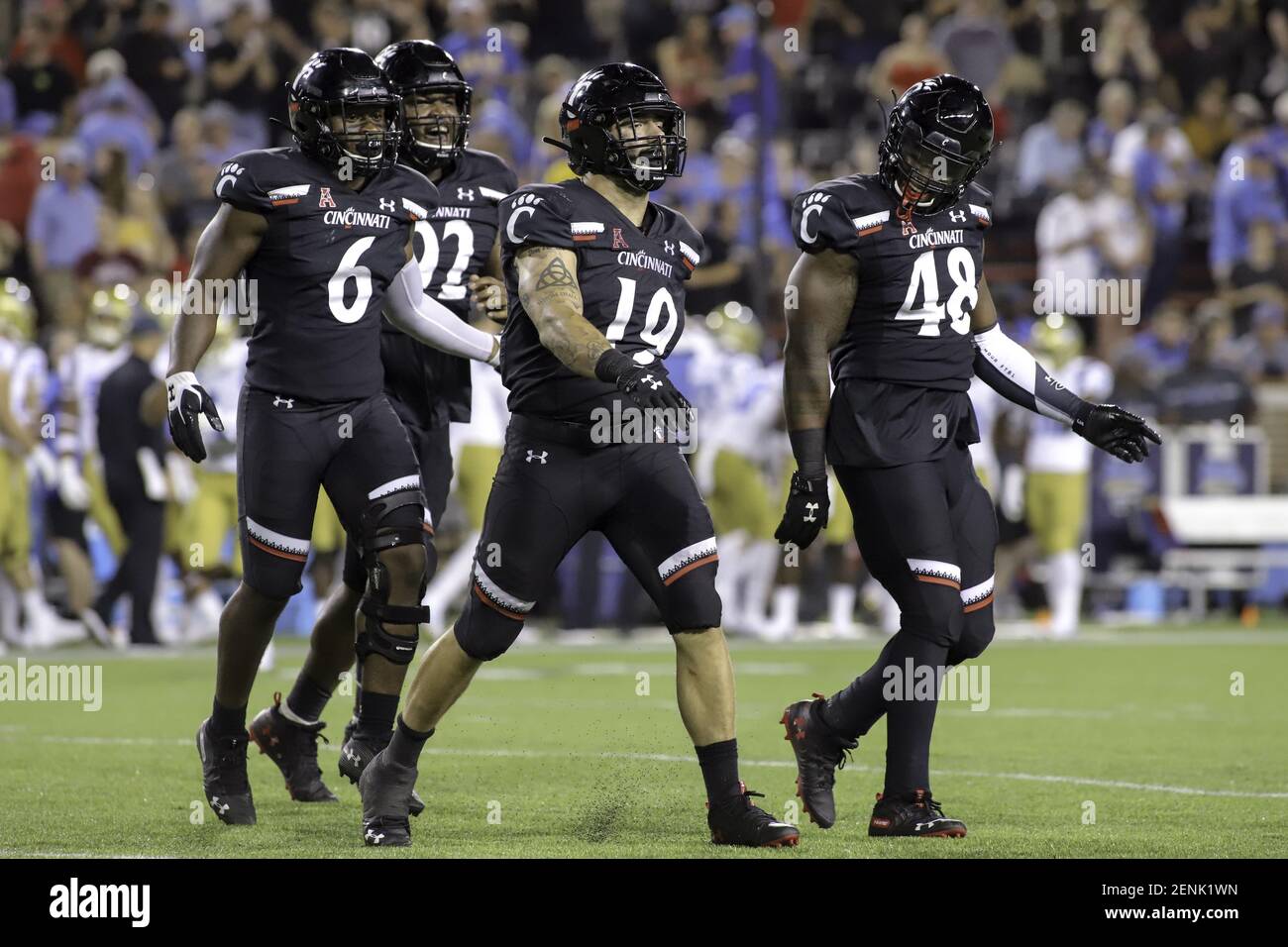 August 29, 2019: Cincinnati's Ethan Tucky (19) struts to celebrate his sack with teammates Perry Young (6) and Kevin Mouhon (48) during an NCAA football game between the Cincinnati Bearcats and the UCLA Bruins at Nippert Stadium in Cincinnati, Ohio. Kevin Schultz/(Photo by Kevin Schultz/CSM/Sipa USA) Stock Photo