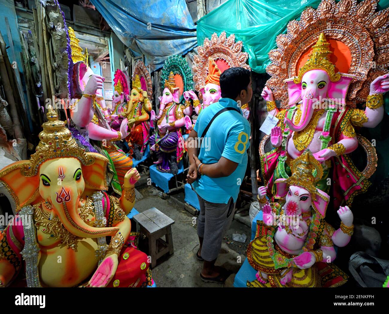 A buyer checks the Lord Ganesha idol at a shop ahead of the Ganesh  Festival. Ganesh Chaturthi festival is the annual worship festival of the  Hindus & it is believed that Lord