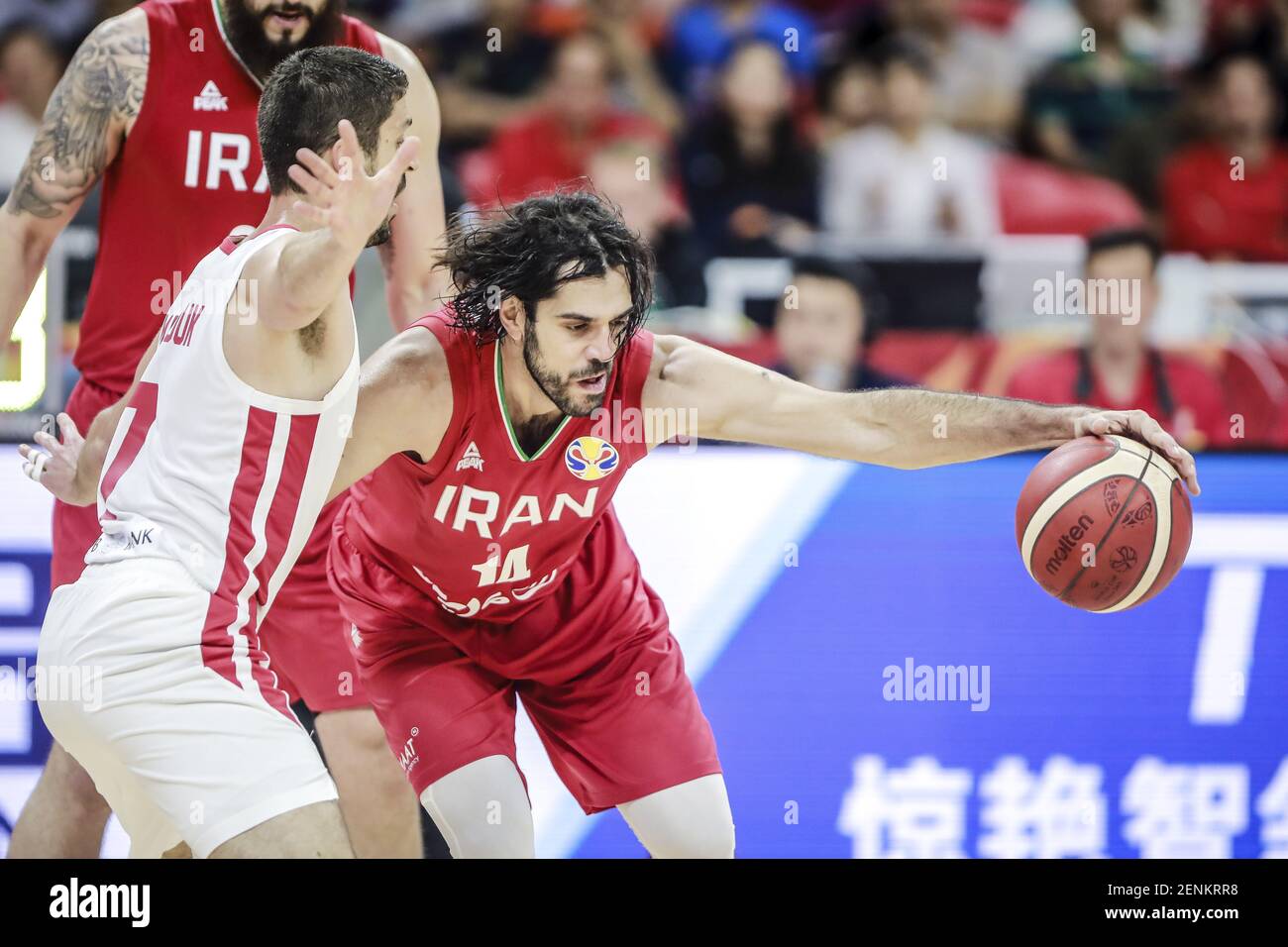 Iranian professional basketball player Samad Bahrami of the Iranian  National Team, right, protects the ball at the second round of Group C 2019  FIBA Basketball World Cup in Guangzhou city, south China's