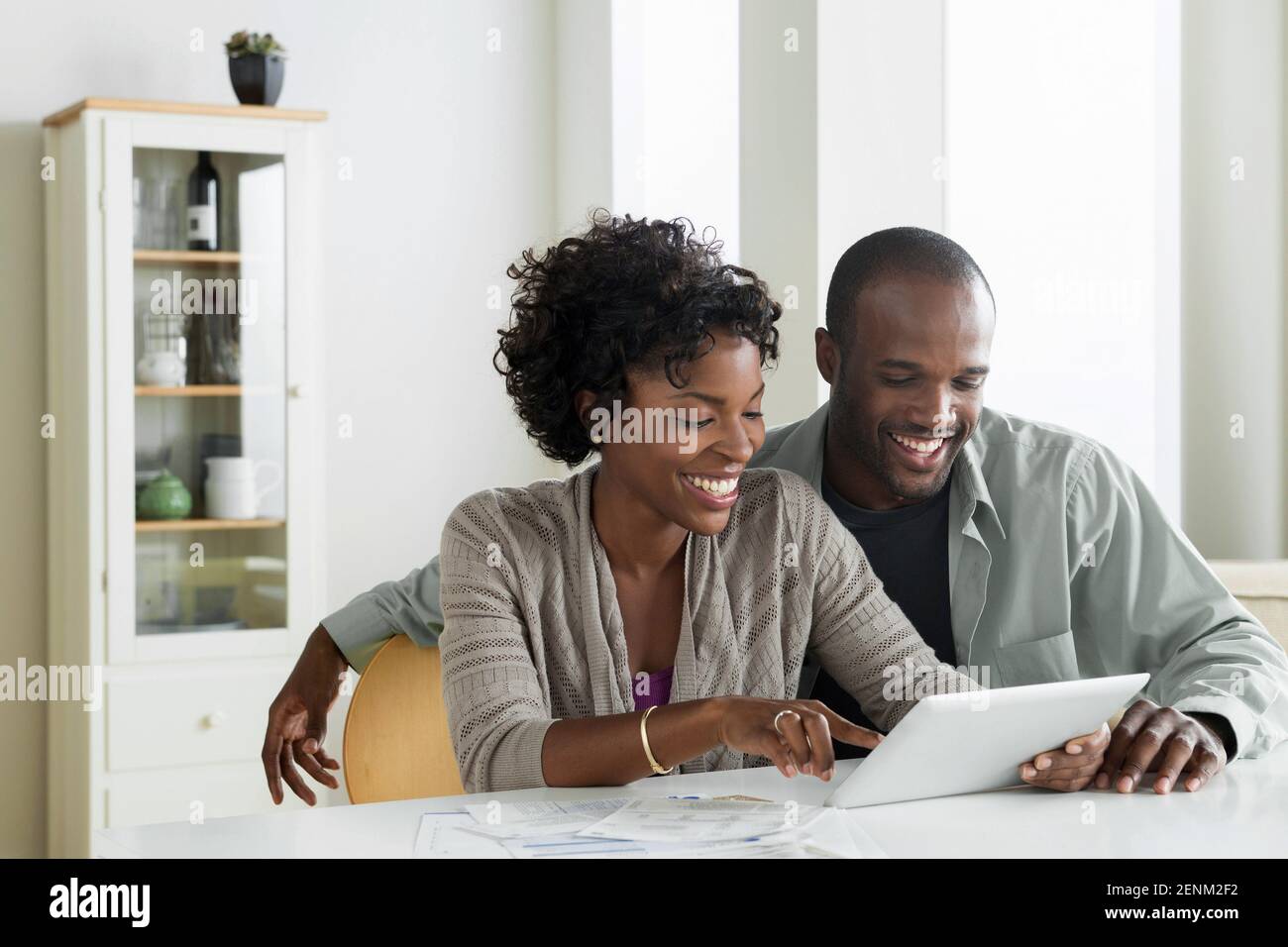 Mid adult couple using digital tablet Stock Photo