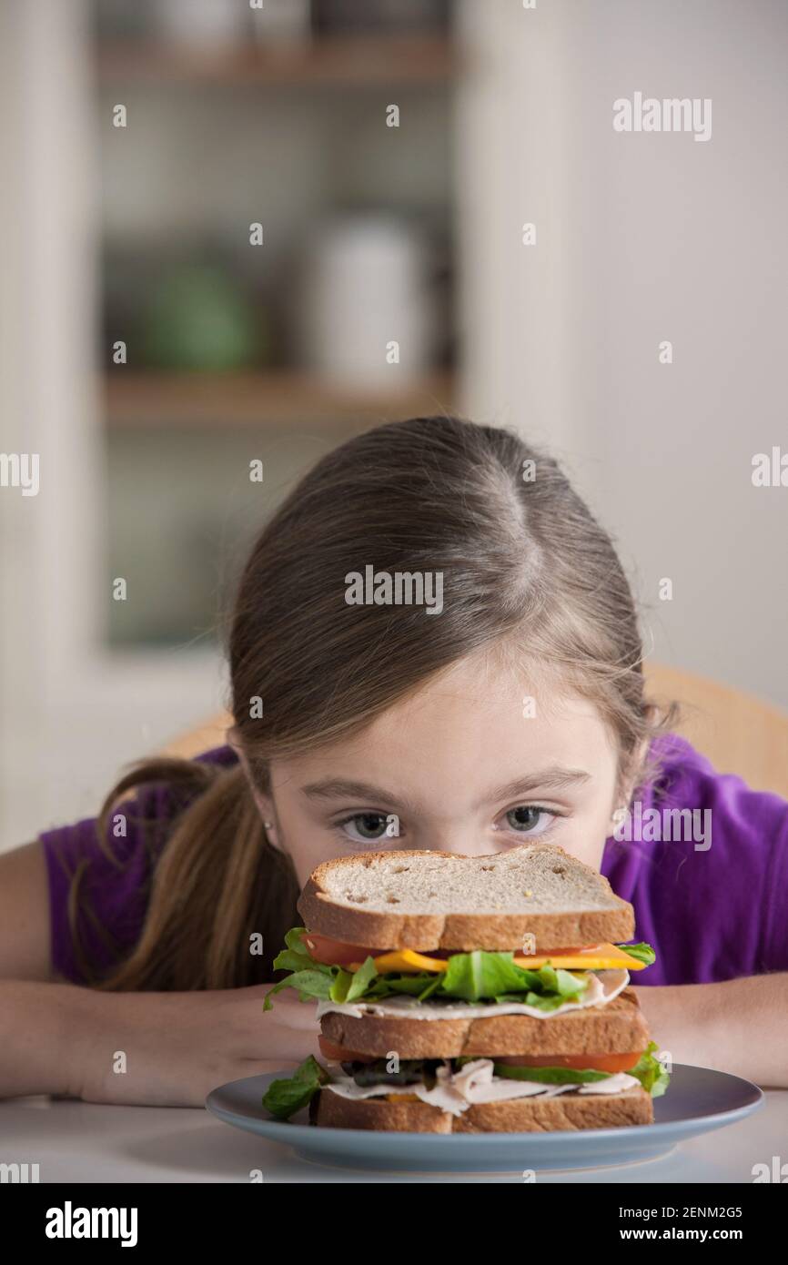Girl staring at sandwich Stock Photo