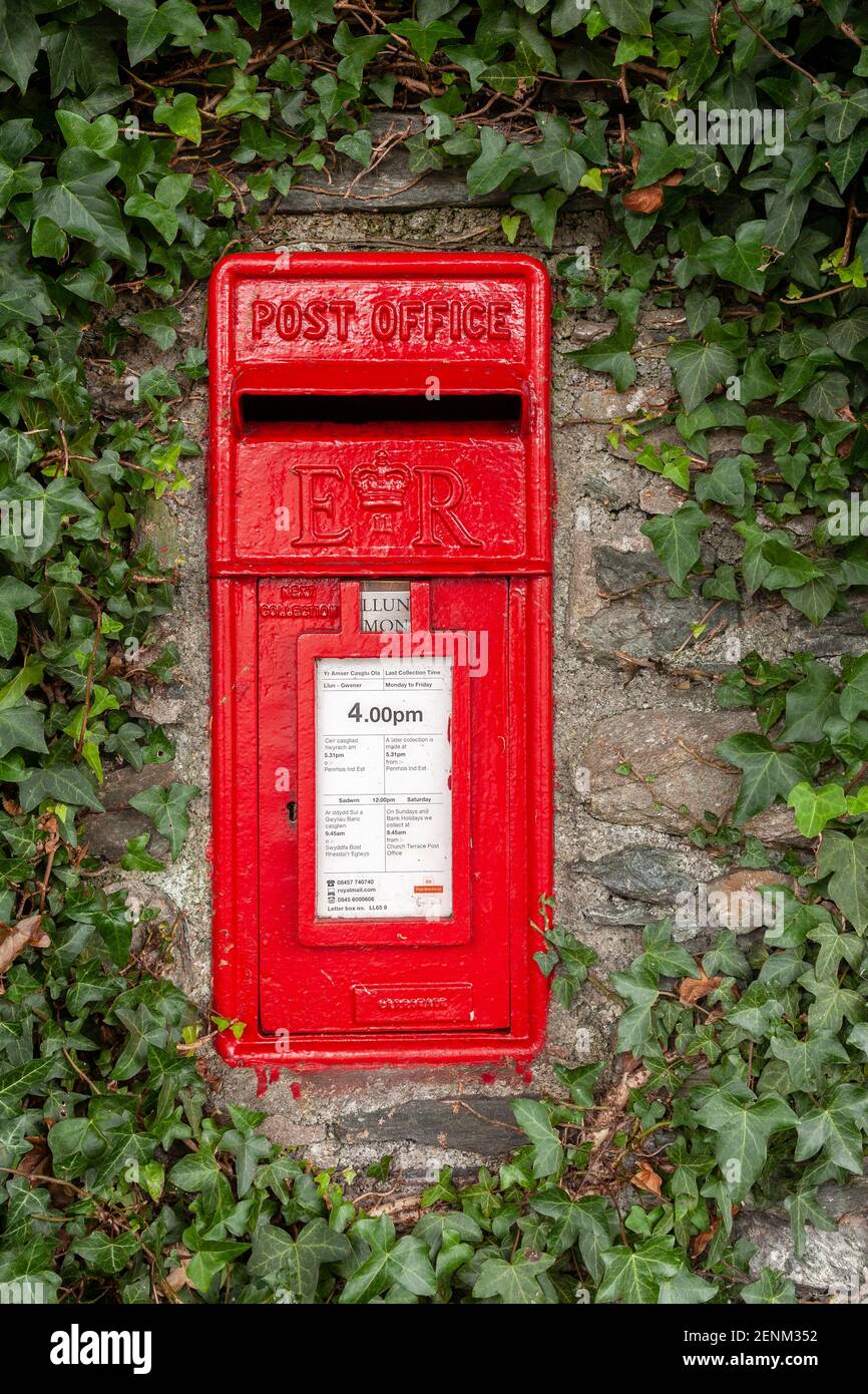 Traditional red UK postbox set in an ivy covered wall Stock Photo