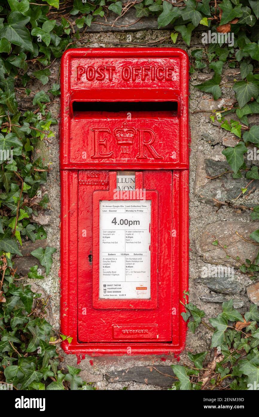 Traditional red UK postbox set in an ivy covered wall Stock Photo