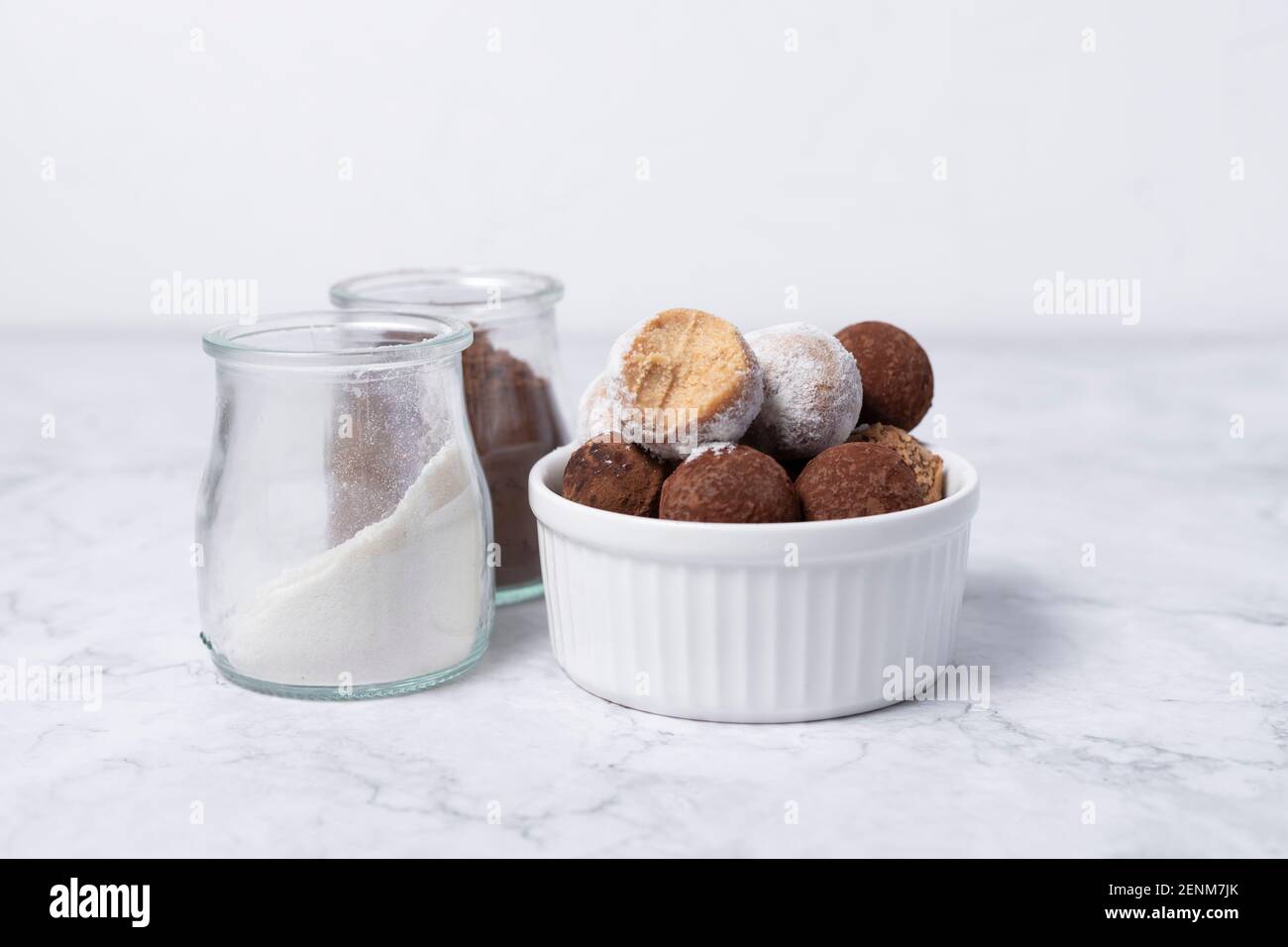 homemade energy balls - truffles made of cocoa and coconut shavings. Stock Photo