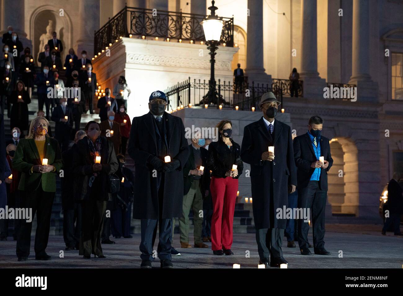 Rep. Jim Clyburn, center, joins members of Congress during a candlelight vigil and moment of silence for the over 500,000 Americans who have died from COVID-19 outside the U.S. Capitol February 23, 2021 in Washington, D.C. Stock Photo