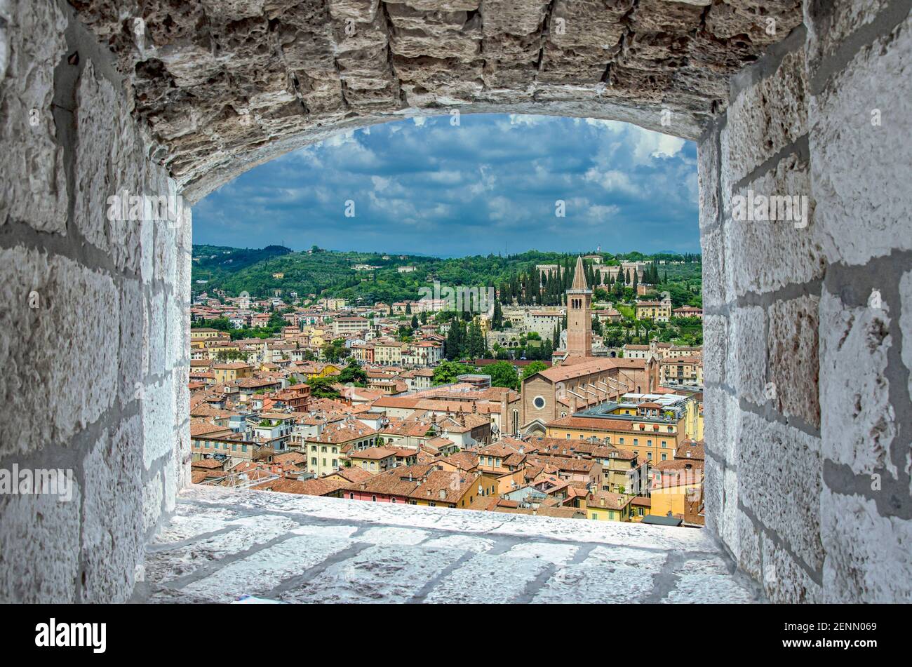 View from stone window on red rooftops and roofs in Verona, Italy. View from above of Verona old town. Stock Photo