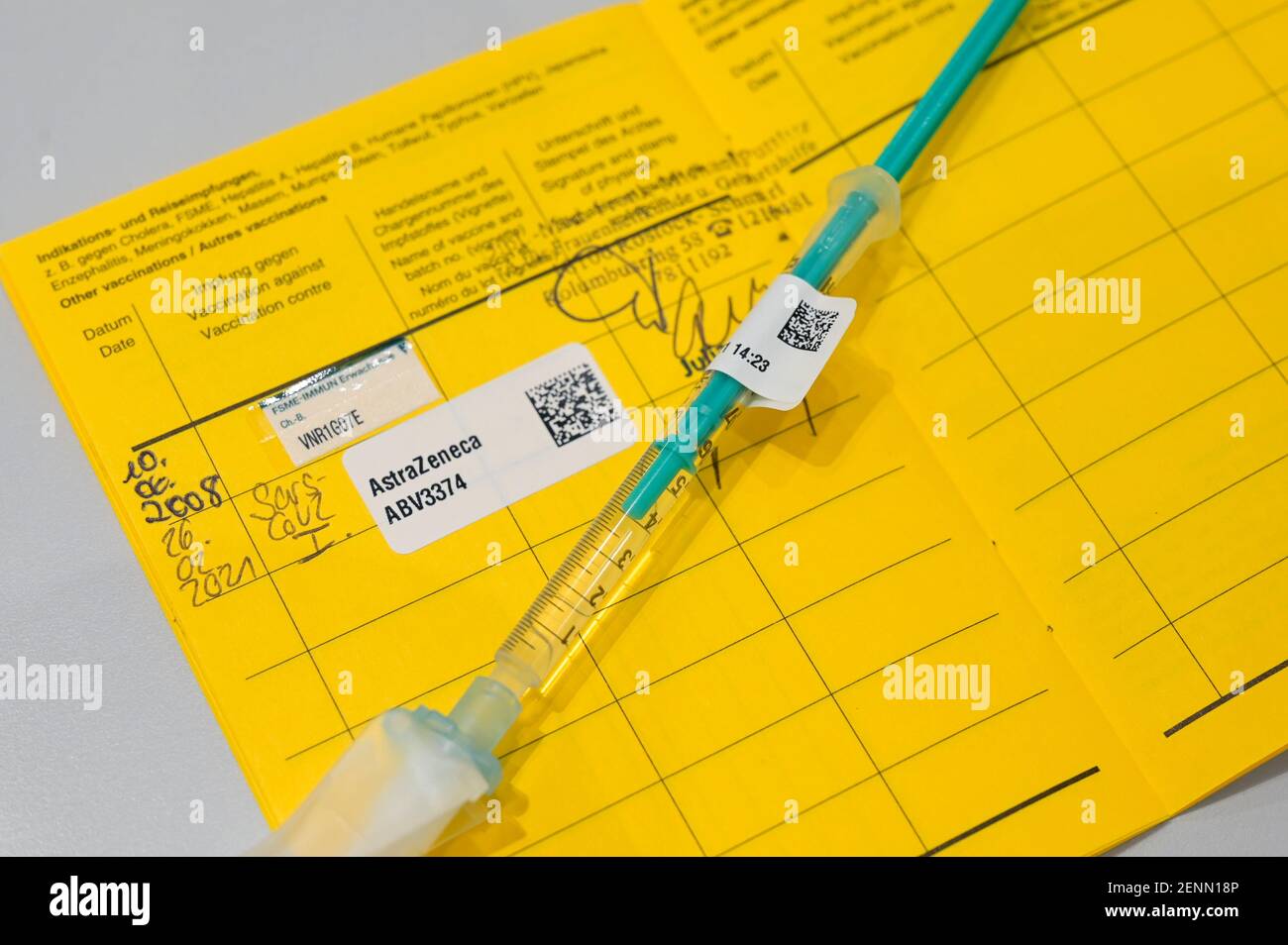 GERMANY, Hamburg, corona pandemic, largest vaccination center in Germany, injection syringe and vaccination pass with sticker of vaccine AstraZeneca against SARS CoV 2 or Covid-19 Stock Photo
